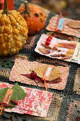 Self-made place cards with autumn leaves