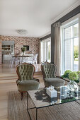 Coffee table and armchairs in open-plan interior