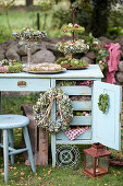 Autumn arrangement with wreaths of moss and hydrangea flowers on an old desk