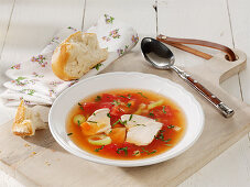 Clear tomato soup with chicken fillet