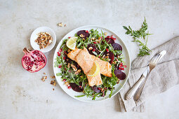 Roast salmon on rocket salad with beetroot and pomegranate seeds