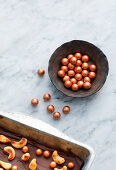 Copper-coloured chocolate balls as decoration for confectionery