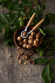 Walnuts in a wooden bowl with a nutcracker