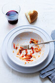 The remains of spaghetti all'amatriciana on a plate