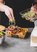 Preparation of veggie burgers with vegetables and sprouts