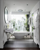 Modern bathroom with freestanding bathtub and glass wall