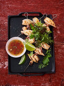 Calamaretti kebabs with nuoc-cham dip and herb salad