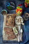 Homemade keto bread with nuts and seeds served blue cheese dip and veggies