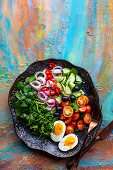 Colourful raw salad with boiled egg