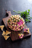 Goat's cheese ball with beets, curry and macadamia nuts