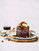 Chocolate pancakes with caramelized bananas and hazelnuts