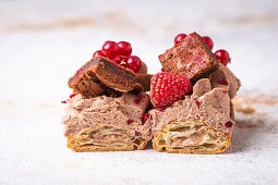Eclairs with chocolate cream, brownie and berries