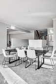 Modern, minimalist, open-plan interior decorated in shades of grey