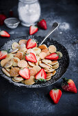 Mini pancake cereal with strawberries