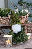 Christmas elves made from twigs, moss and cotton, silver balls as a nose and on the pointed cap