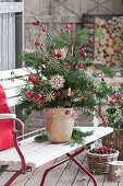 Christmas bouquet made from branches of Nordmann fir, pine and crabapple, decorated with straw stars