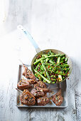 Garlicky lamb cutlets with Sicilian-style greens