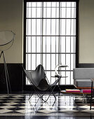 Butterfly chair in front of lattice window in designer living room