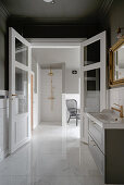 Double door in luxurious bathroom in grey and white with marble tiles