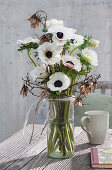 White spring bouquet of anemones and maple twigs