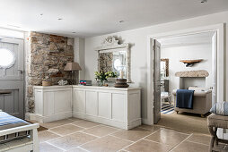 Limestone floor tiles in entrance hall with upcycled shop counter painted in Pure chalk