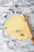Rolled out shortcrust pastry with cut-out lettering