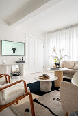 Bright living room with coffee tables, armchair and console table