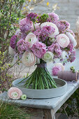 Standing bouquet with pastel-colored ranunculus