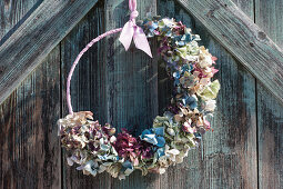 Door wreath made of hydrangea blossoms in different colors