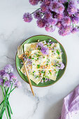 Chives flowers laminated ravioli with cottage cheese and pine nuts