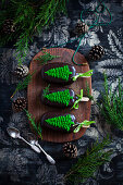 Chocolate popsicles with green icing in the shape of fir trees