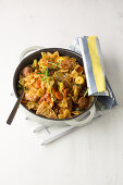 Tuscan dish with pork steak, salsiccia, farfalle and vegetables