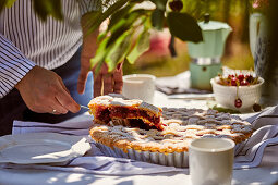 Cherry pie served outside on the table