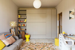 Gray cupboard with shelves and matching sofa in the living room