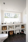 White washstand with shelves below window in bathroom