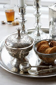 Silver platter with a sugar bowl, candles and biscuits