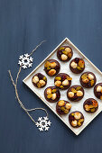 Dark raw chocolate pralines with nuts and dried fruit