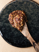 Homemade coarse mustard on a wooden spoon