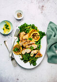 Baked lemon chicken with green asparagus and broccolini