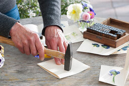 Designing greeting cards with flowers by hammering, an imprint of the flowers appears on the opposite side
