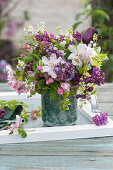 Spring bouquet of lilac, crabapple, lily of the valley, tulip, garlic mustard and climbing cucumber
