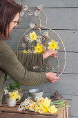 Woman creating hanging Easter decorations on the terrace