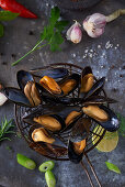 Cooked mussels on a ladle