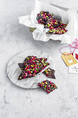 Broken chocolate with raspberries and pistachios