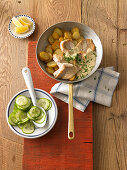 Pan fried fish with fried potatoes and cucumber salad