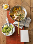 Hamburger panfish with fried potatoes and cucumber salad