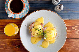 Eggs Benedict breakfast - Two poached eggs on muffins, with ham and hollandaise sauce