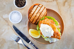 Battered fish in a brioche bun with lettuce and tartare sauce