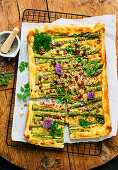 Puff pastry tart with green asparagus and bacon