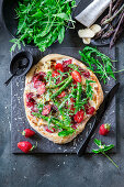 Strawberry and asparagus pizza with rocket